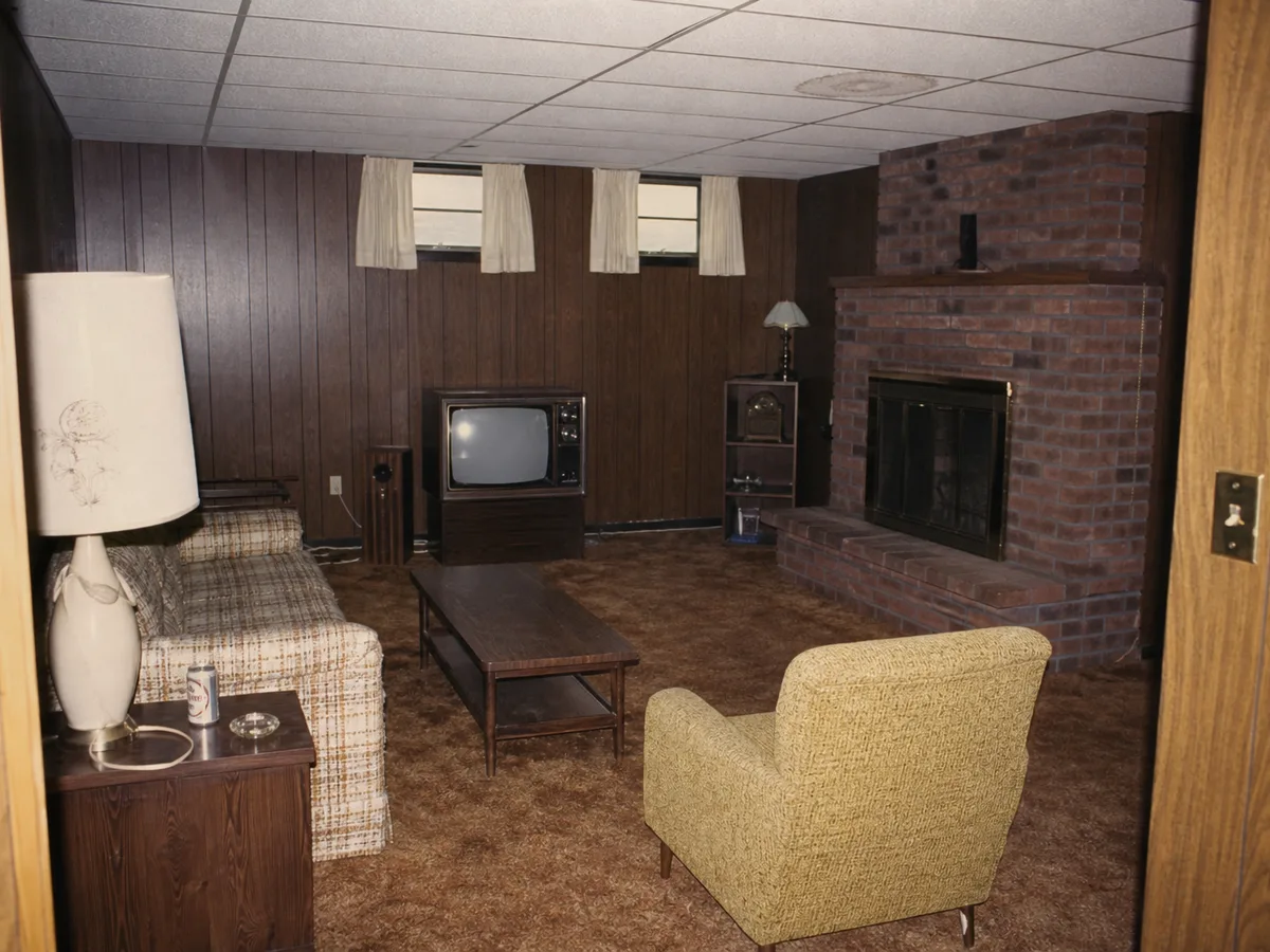 1970s wood-paneled rec room with brown carpet before suite conversion, Burnaby