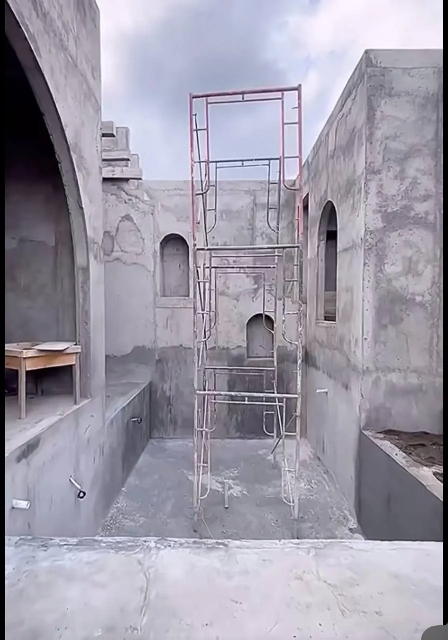 White Courtyard Pool & Arched Minimalist Shell — before — Raw concrete pool shell with scaffolding and arched niches, then finished white plaster courtyard with turquoise water.