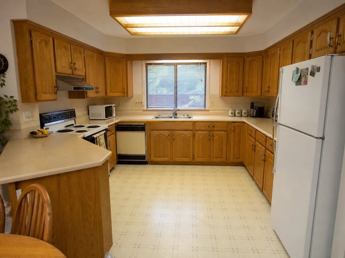 Original 1990s oak kitchen with laminate counters before the update, Surrey