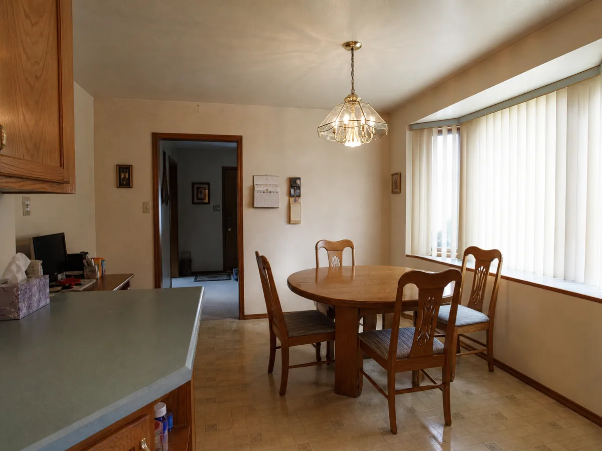 Dated eating nook with worn linoleum floor before the update, Surrey